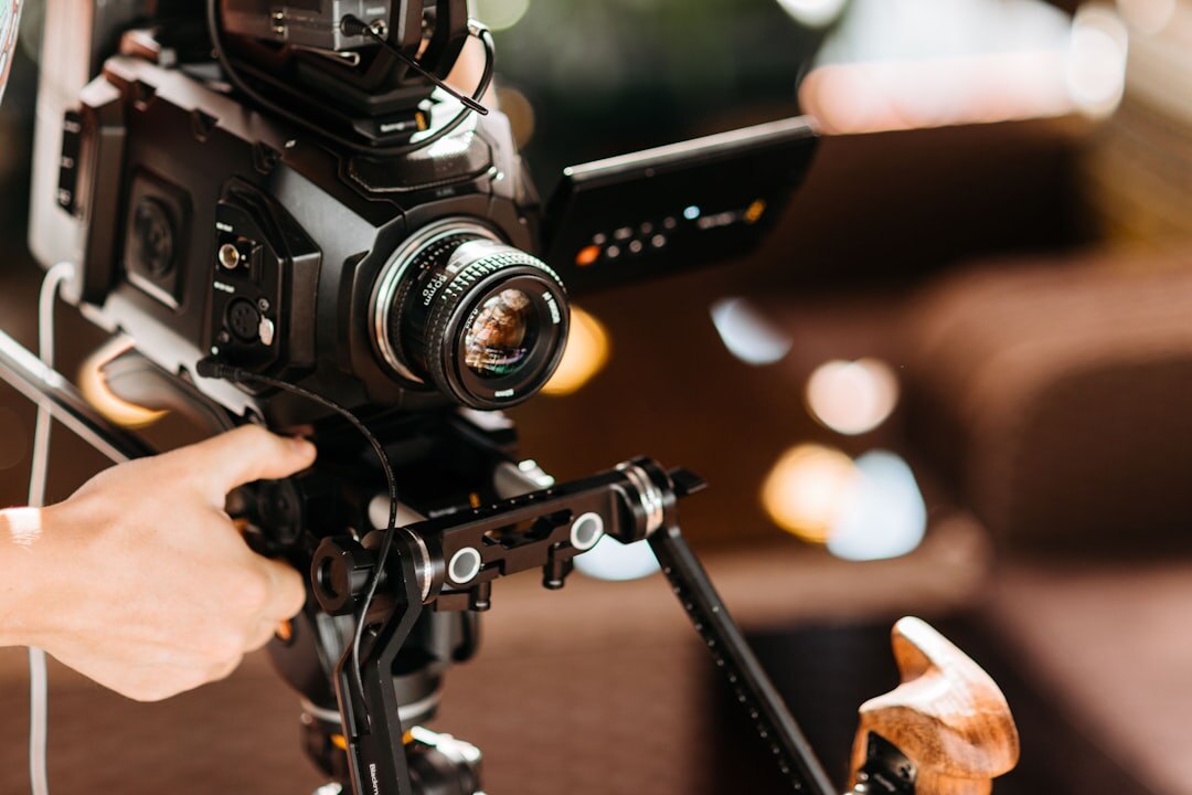 Professional video camera on tripod in a modern TV studio