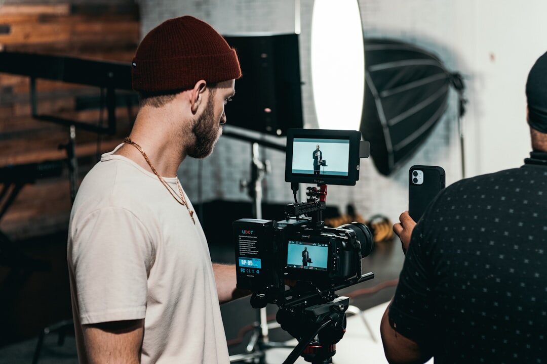 Videographer filming with professional camera equipment